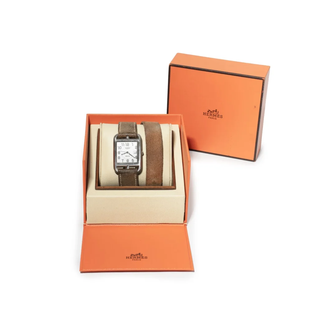 Vintage Hermès rectangular wristwatch with brown leather strap presented in its original orange presentation box alongside an extra matching strap