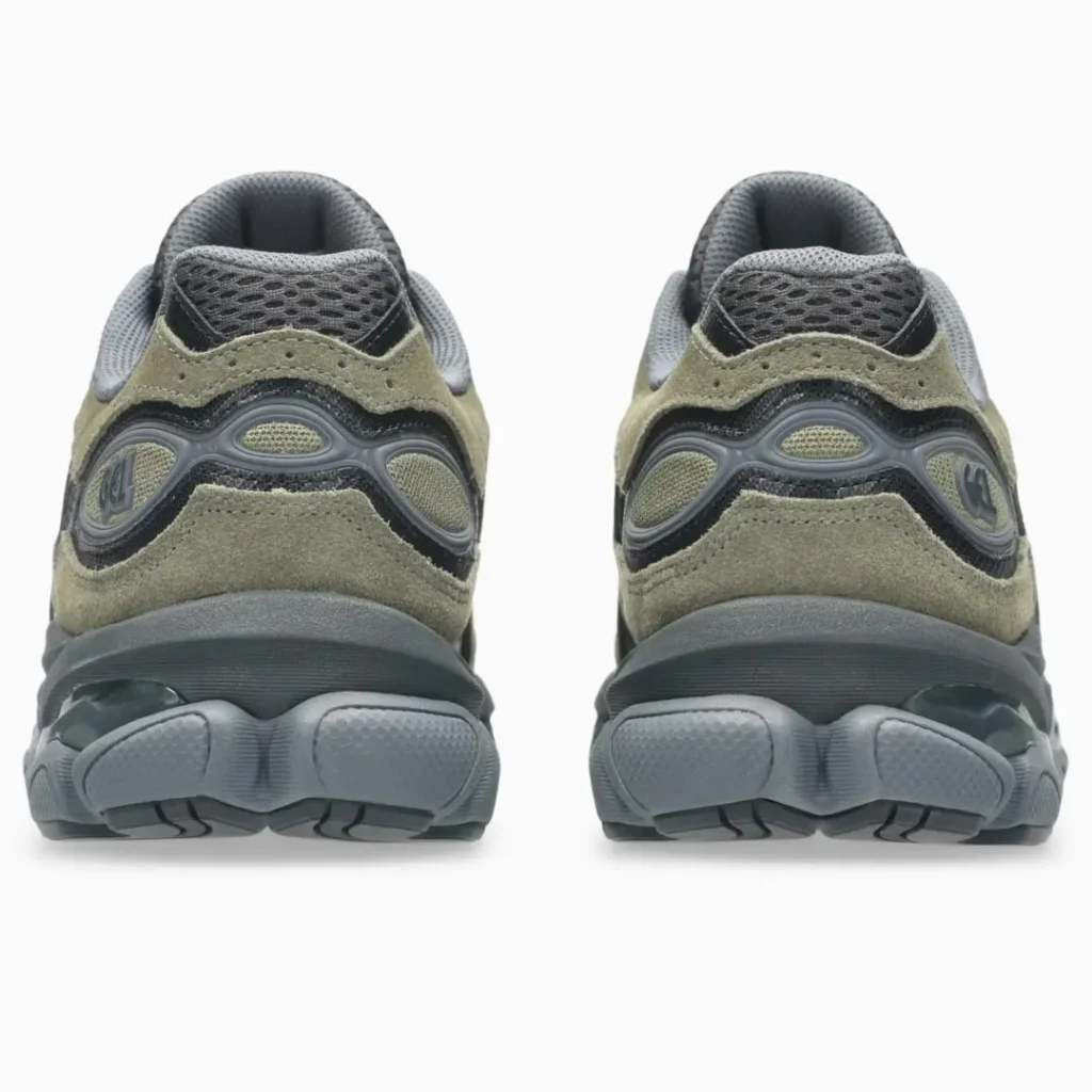 Rear view of a pair of olive green and dark gray ASICS GEL-NYC shoes, showing the padded mesh collars, suede heel panels, GEL branding, and segmented outsole