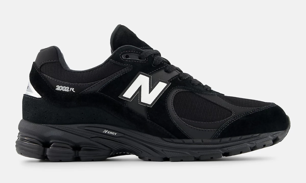 Black New Balance 2002R GORE-TEX shoe shown in a clean lateral profile, featuring black suede overlays, breathable mesh underlays, tonal leather panels, white "N" logo, ABZORB midsole, and reflective silver GORE-TEX heel detail against a light gray background