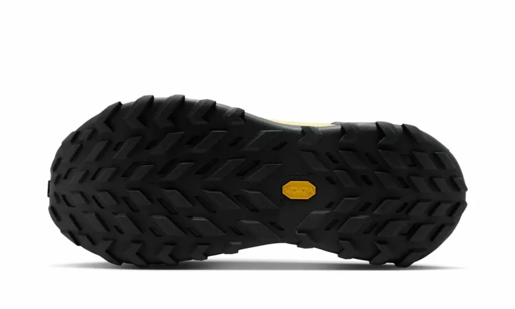 Outsole view of the pale volt Nike ACG Zegama Hike highlighting the durable black Vibram tread with deep traction lugs for technical terrain
