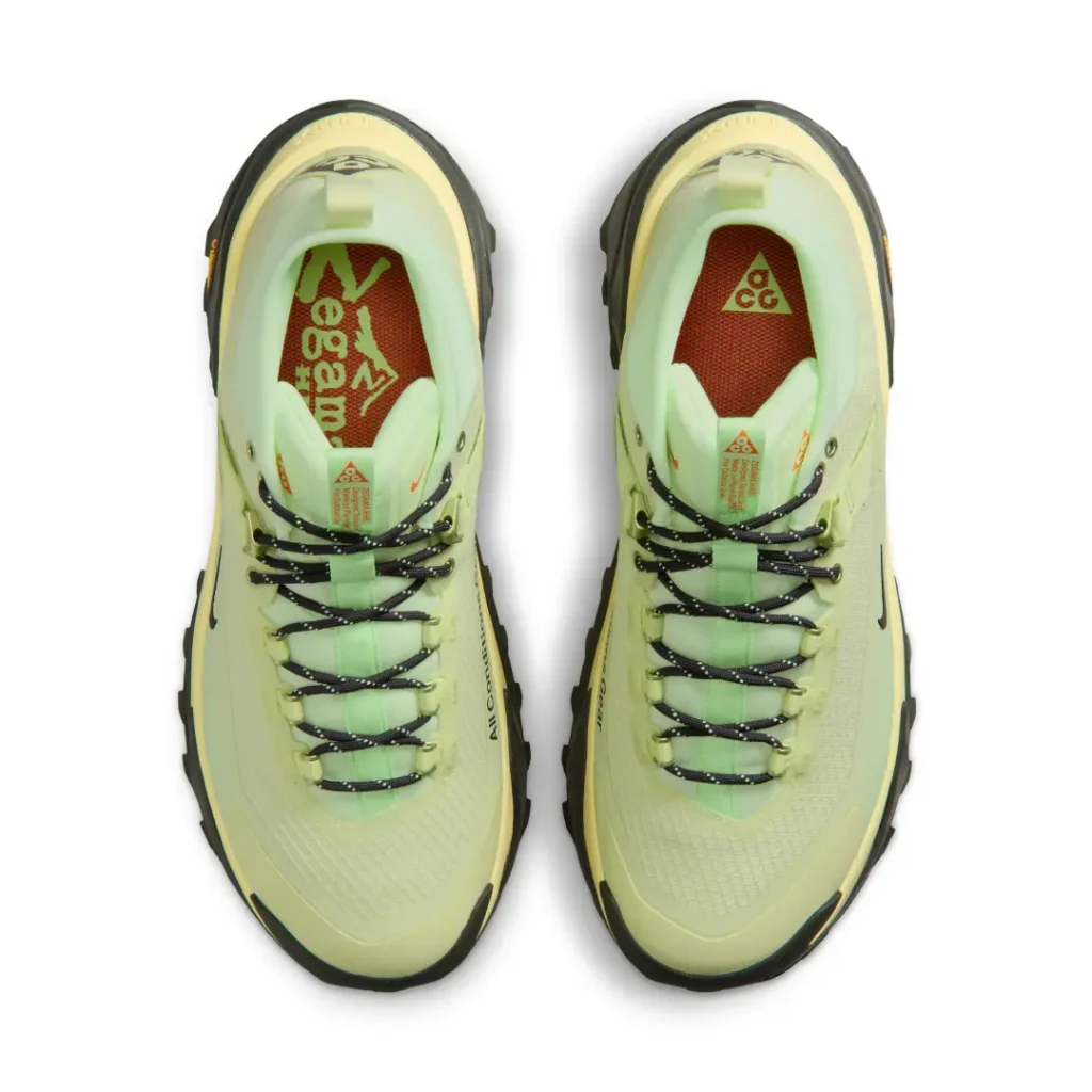 Top-down view of the pale volt Nike ACG Zegama Hike pair revealing black speckled hiking laces, padded ankle collar, and ACG-branded footbed