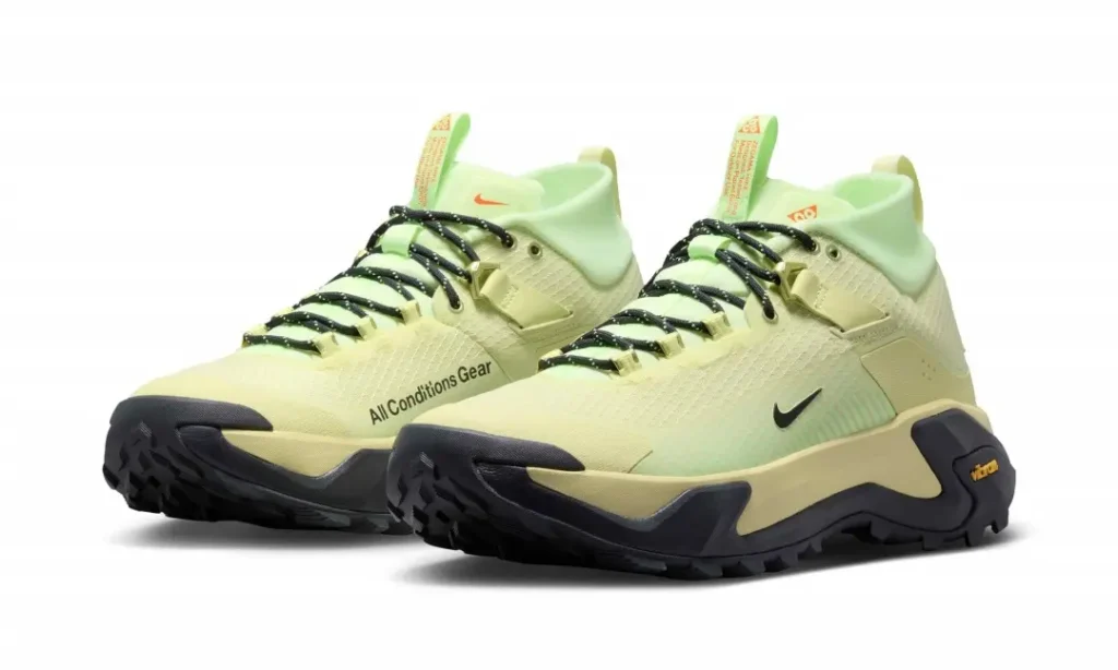 Three-quarter front angle of the pale volt Nike ACG Zegama Hike pair emphasizing the streamlined silhouette, rugged outsole, and lightweight hiking design