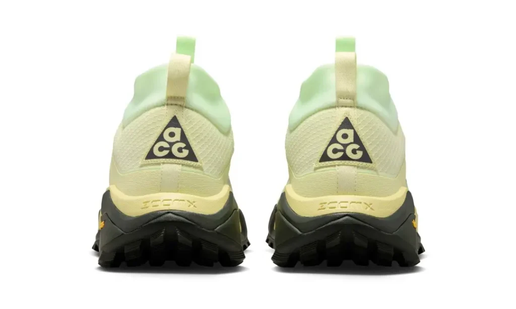 Rear view of the pale volt Nike ACG Zegama Hike showing black ACG heel logos, pull tabs, ZoomX branding, and reinforced heel structure