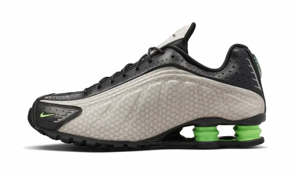 Lateral profile of the Nike Shox TL highlighting the textured pearl gray sidewall, black leather upper, and neon green Shox cushion column