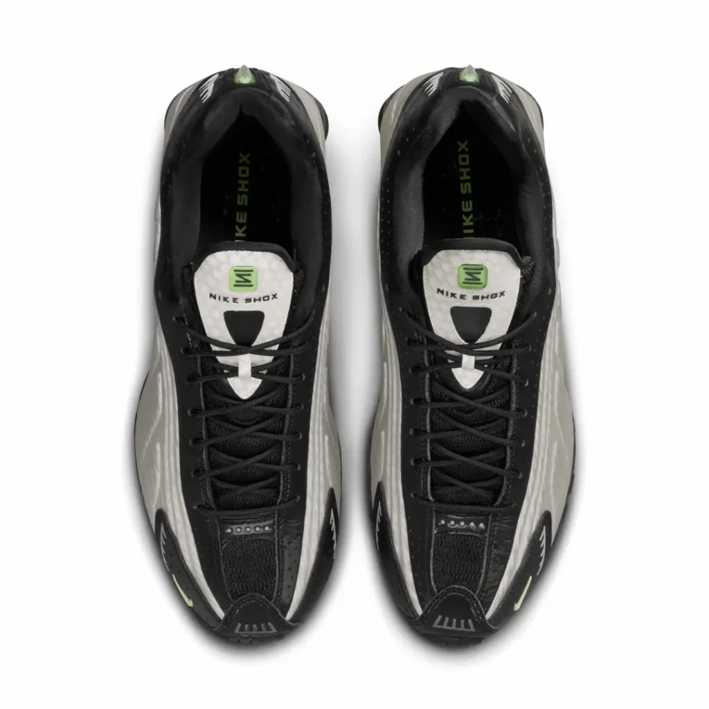 Top-down view of the Nike Shox TL pair showing the lace system, tongue branding, and padded black interior