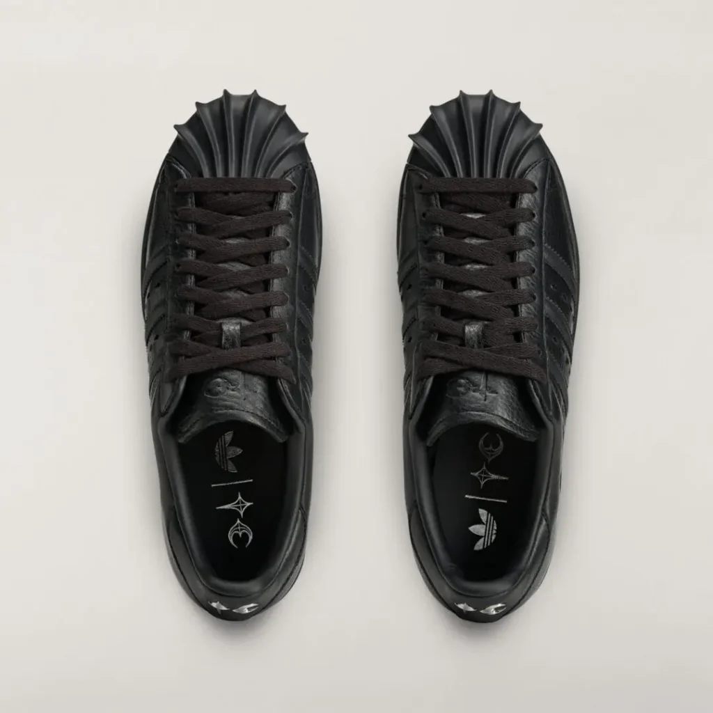 Top-down view of the black adidas Originals by Taqwa Bint Ali Superstar highlighting oversized shell toes, tonal laces, and co-branded insole