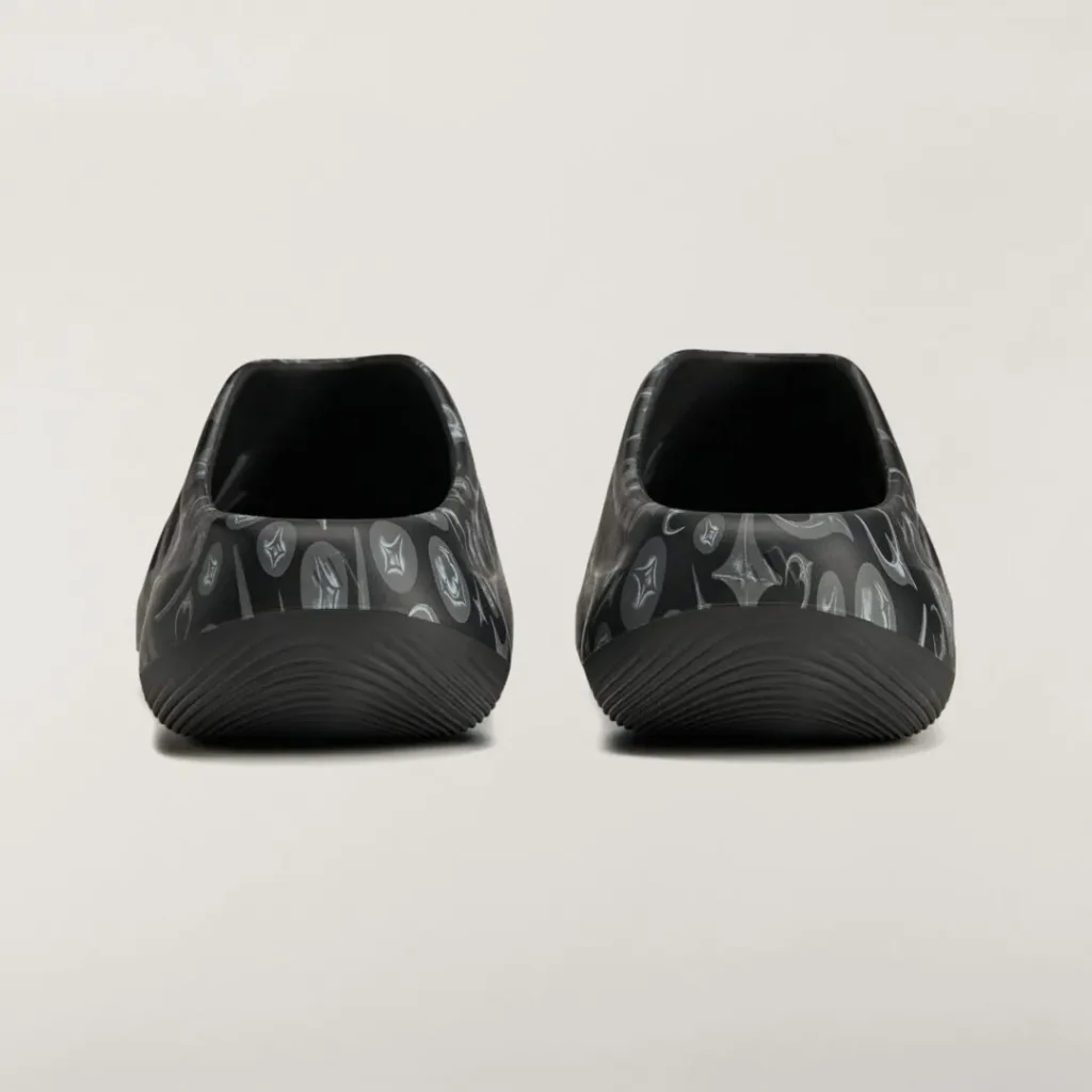 Rear view of the adidas Originals by Taqwa Bint Ali Adistar Cushion Mule highlighting its open-back sil and graphic upper