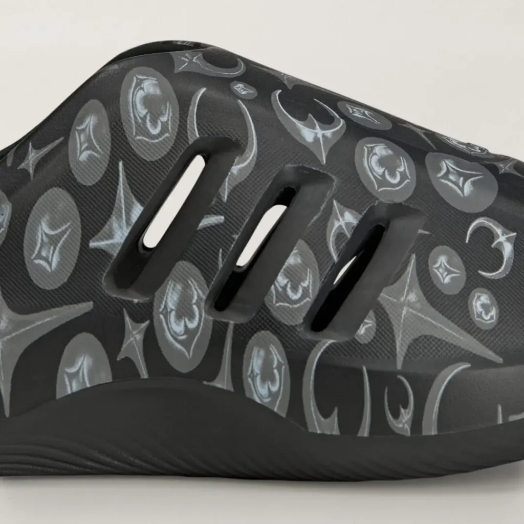 Close-up of the adidas Originals by Taqwa Bint Ali Adistar Cushion Mule showing the monochrome graphic print and ventilation opening