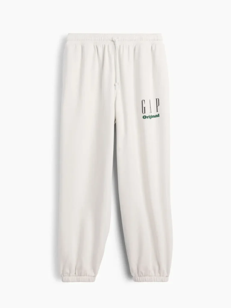 Cream GAP Original jogger sweatpants with an elastic drawstring waistband, cuffed ankles, side pockets, and a small green logo printed on the upper left leg
