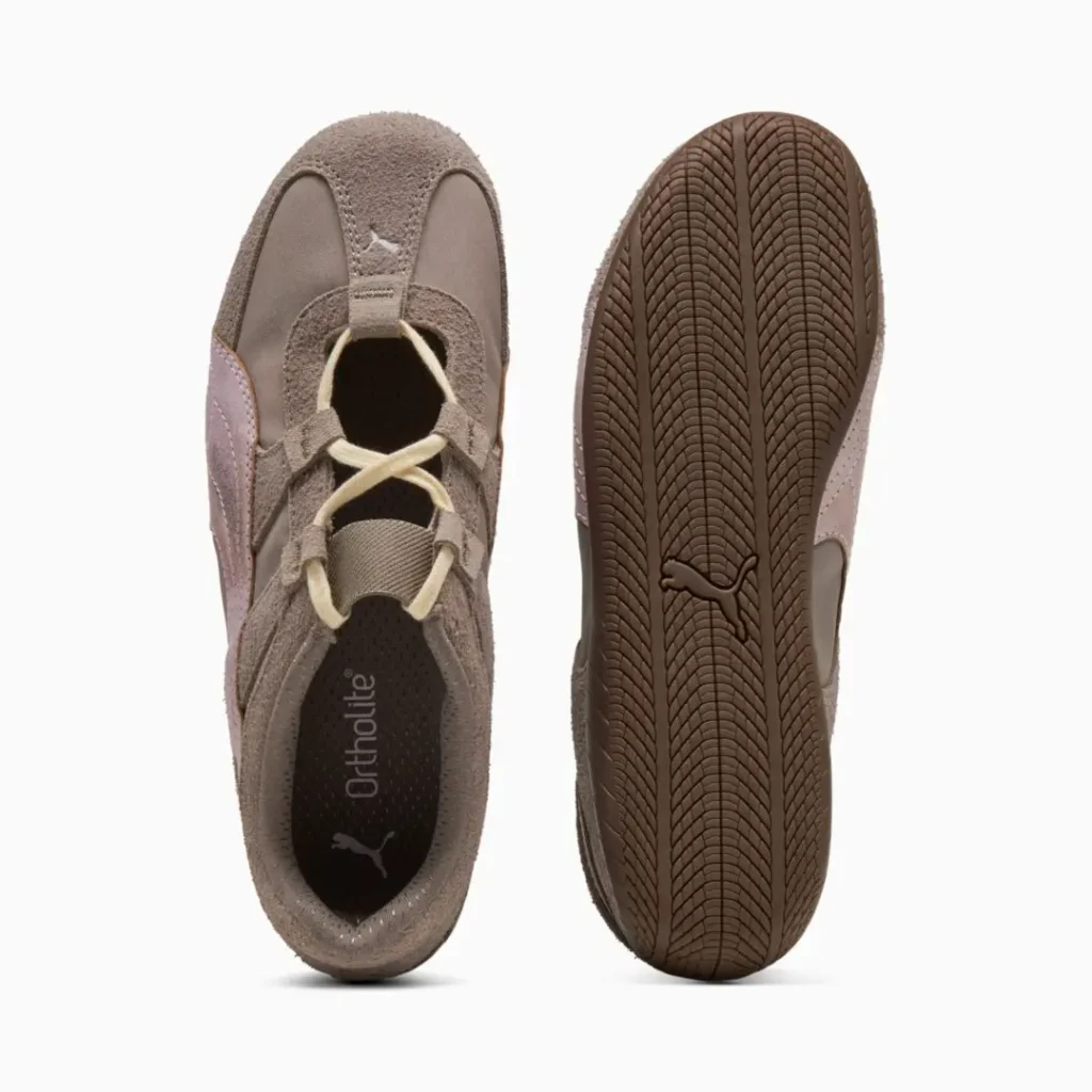 Top and outsole view of the sneaker showing the Ortholite insole, elastic strap across the instep, cream laces, and herringbone-pattern brown rubber outsole with Puma brand