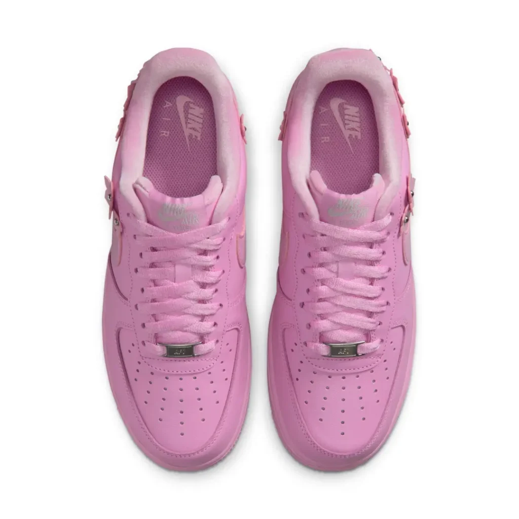 Top-down view of the pastel pink Nike Air Force 1 with tonal laces, padded collar, and Nike Air brand