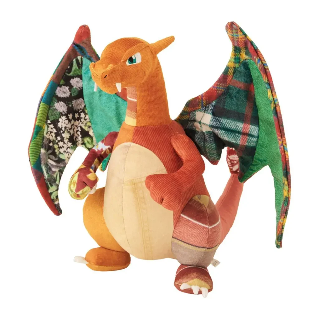 Sean Wotherspoon × Pokémon Center Charizard plush featuring corduroy, plaid, floral, and textured fabric panels throughout its wings, tail, and limbs, blending classic Pokémon design with recycled-look patchwork craft