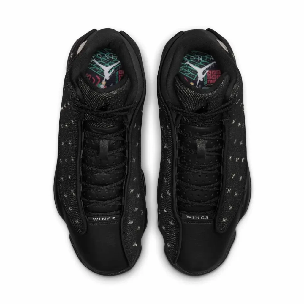 Top-down view of the Air Jordan 13 "Wings" reveals black rope laces, perforated leather tongue, Wings-branded tongue tag, and custom graphic insole