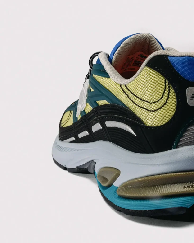 lose-up of the lateral heel section, featuring textured lime mesh, black support cage, white reflective strips, translucent N logo, and sculpted ABZORB midsole