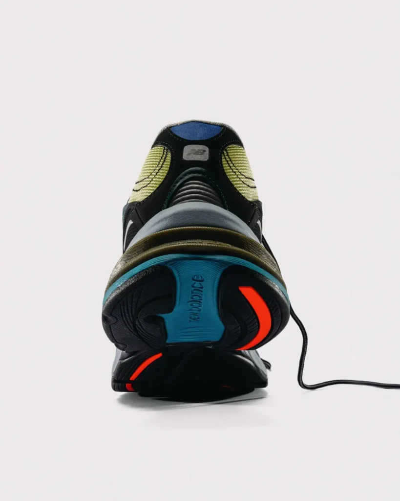 ear view of the New Balance x Baklava 281, highlighting the blue heel insert, ribbed heel support, exposed ABZORB cushioning, and orange outsole accent