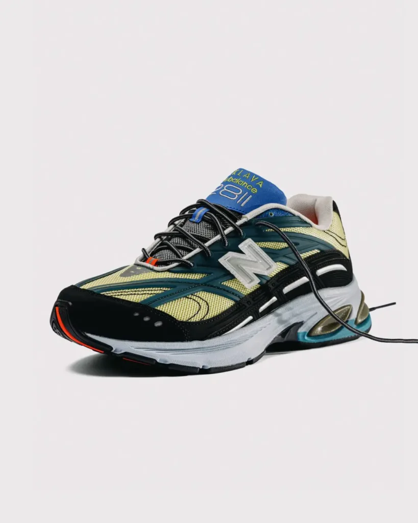 Three-quarter view of the New Balance x Baklava 281 sneaker, showcasing layered mesh construction, translucent oversized N logo, sculpted ABZORB midsole, and contrasting blue, lime, black, and teal color palette