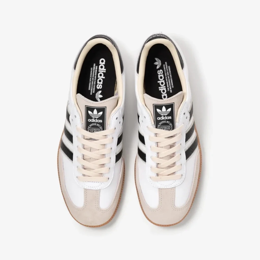 Top-down view of the white adidas Samba displaying cream laces, Trefoil tongue branding, and black insole graphic