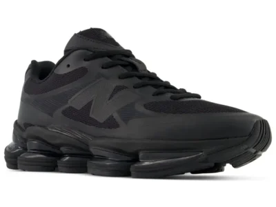 Black New Balance ABZORB 2000 shoe shown from a front lateral angle, featuring a breathable mesh upper with synthetic overlays, tonal black "N" logo, black laces, and a segmented ABZORB SBS pod midsole against a white background