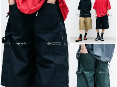 Close-up front view of black CLÉSSTE × +phenix WINDSTOPPER by GORE-TEX LABS worker half pants, highlighting oversized utility pockets, multiple zip compartments, reinforced double-knee construction, and relaxed wide-leg sil
