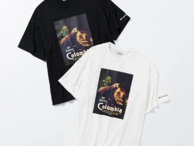 Black and white Columbia graphic Tee featuring a vintage-inspired mountain climbing illustration with Gachapin on the front, displayed in a clean studio flat lay