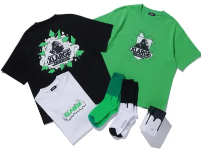 Flat lay of the XLARGE x LIXTICK collection featuring black, white, and bright green graphic T-shirts, matching green and black crew socks, and co-branded packaging arranged on a clean white background