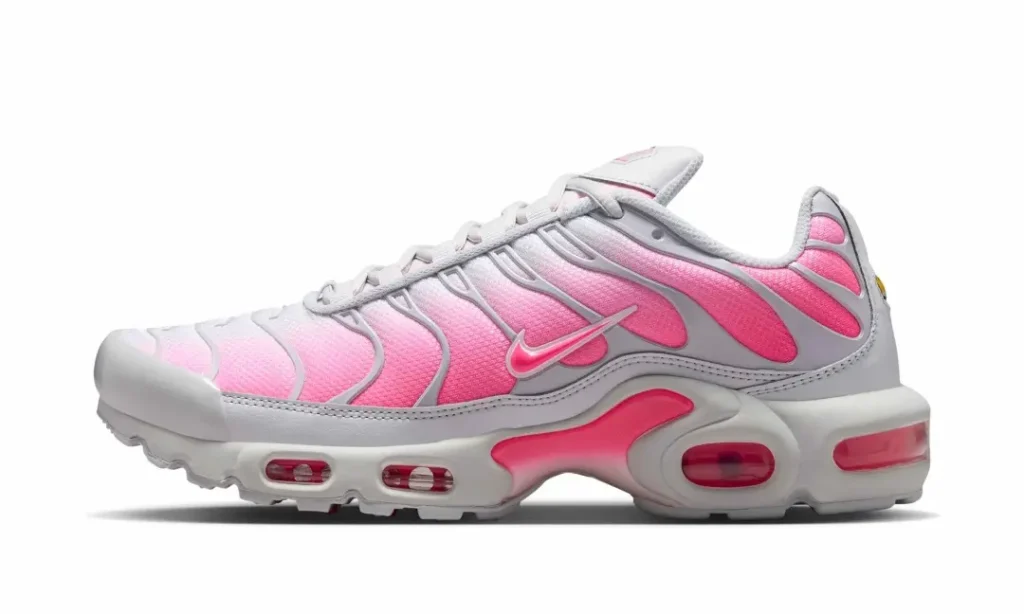 White and gradient pink Nike Air Max Plus shown in profile with TPU wave overlays, Tuned Air cushioning, and bright pink Air unit