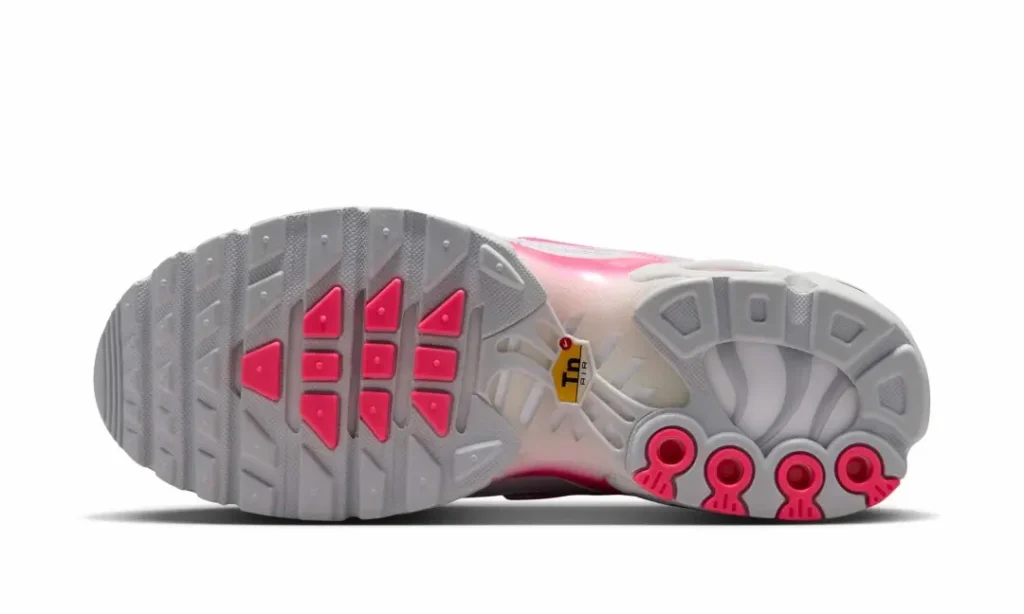 Bottom view of the Nike Air Max Plus reveal the segmented rubber outsole, Tuned Air support structure, and pink traction pod