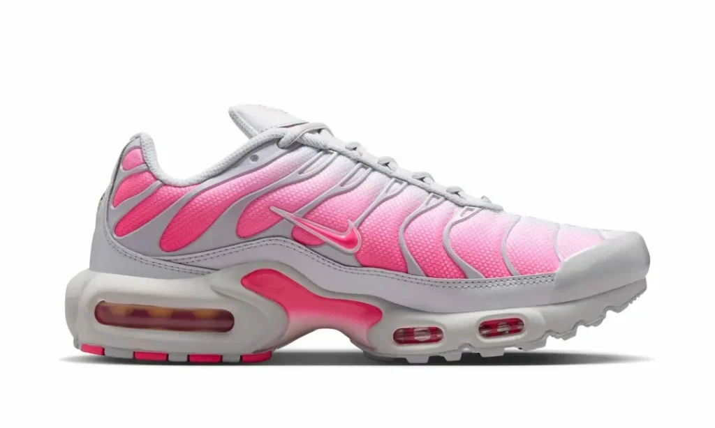 Medial profile of the white and pink Nike Air Max Plus highlighting the gradient mesh upper, gray overlays, and visible Air cushion