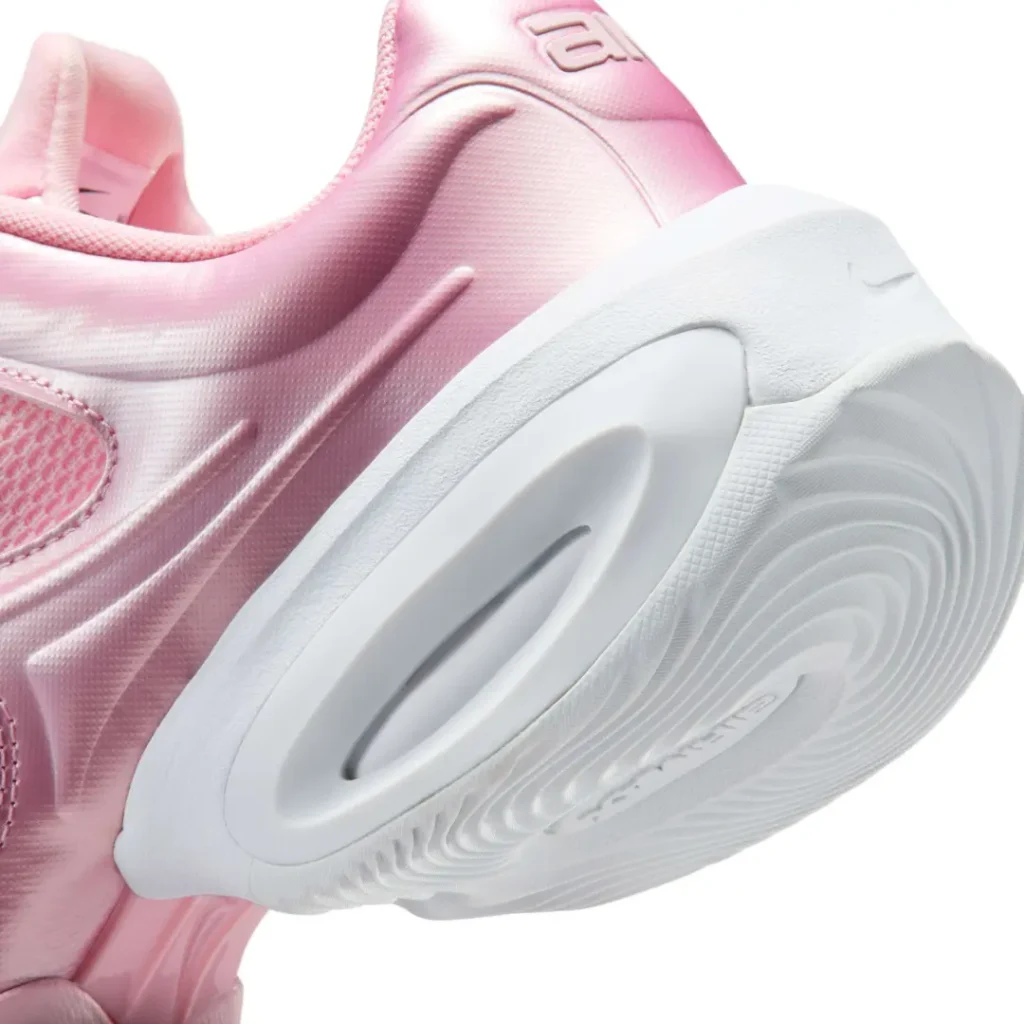 Detailed close-up of the oversized white heel cushion, sculpted midsole, and metallic pink heel construction