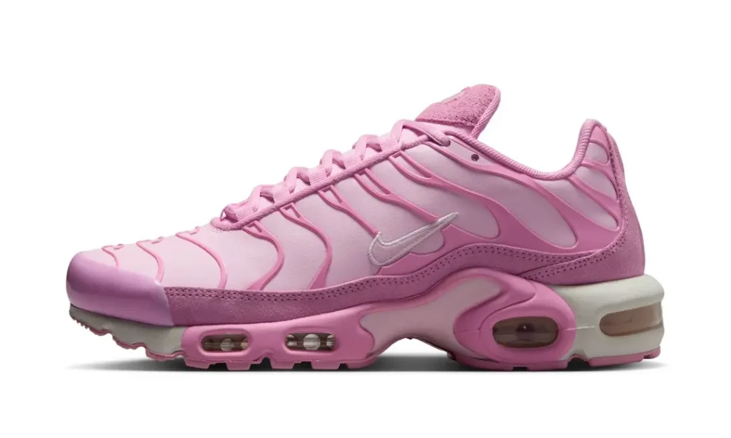 Soft pink Nike Air Max Plus shown in profile with tonal TPU wave overlays, suede mudguard, visible Air cushioning, and a pastel monochrome finish