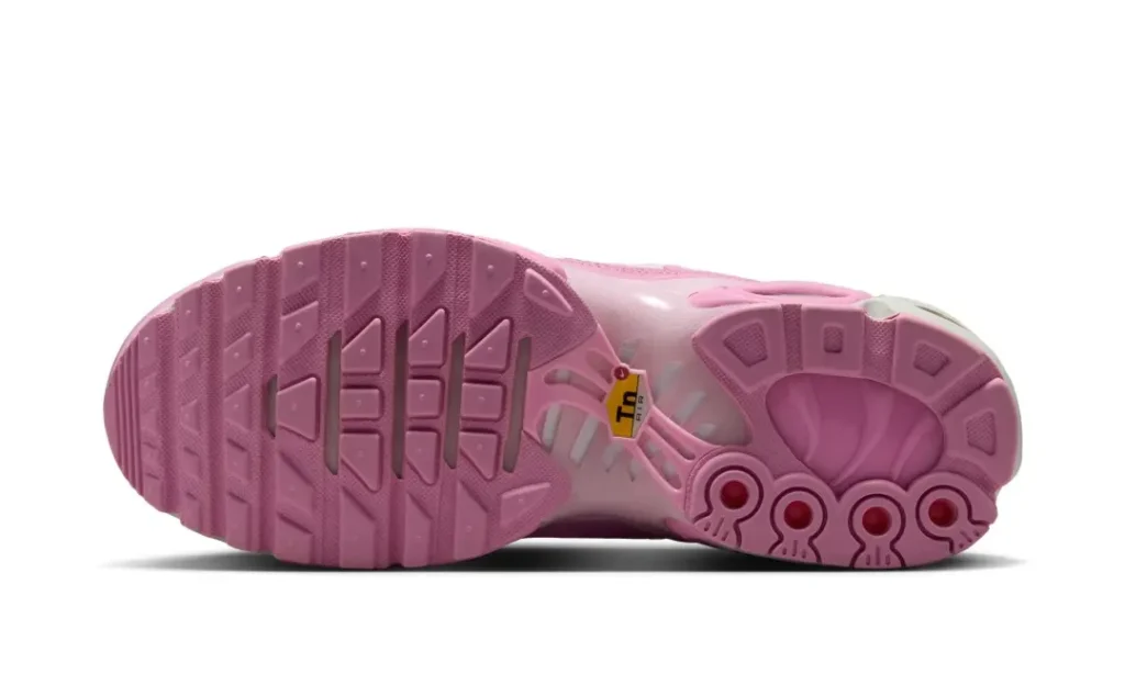 Bottom view of the pastel pink Nike Air Max Plus featuring the full rubber traction pattern, Tuned Air support plate, and tonal outsole design