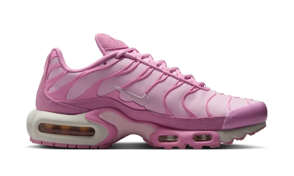 Medial profile of the monochromatic pink Air Max Plus displaying flowing TPU overlays, visible Air units, and layered cushion