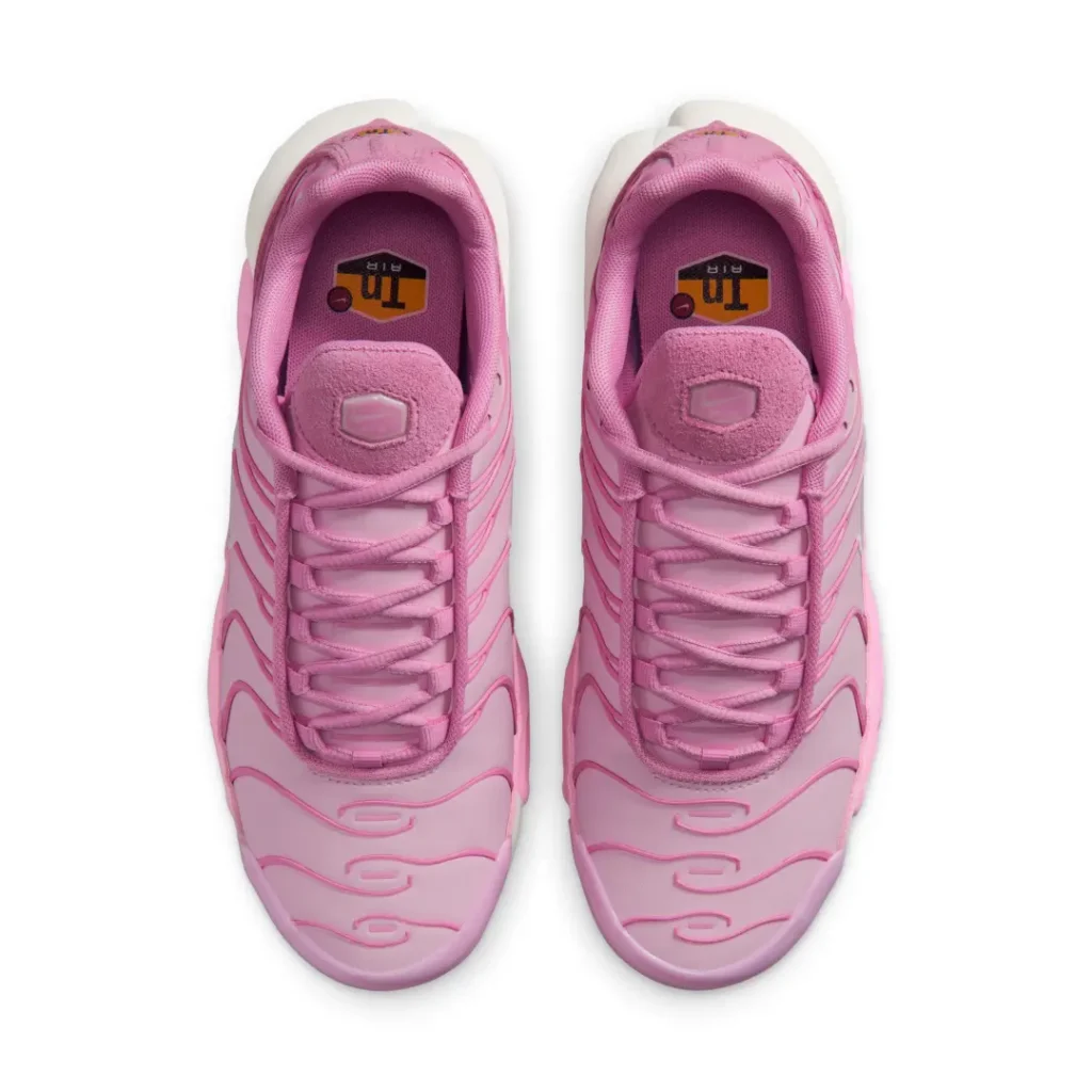 Overhead view of the pastel pink Air Max Plus pair highlighting tonal laces, suede tongue tops, padded collars, and Tuned Air insole