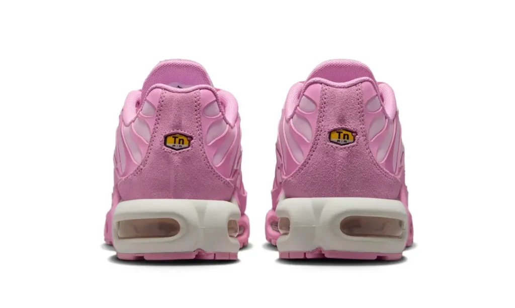 Heel view of the Air Max Plus pair show suede heel panels, Tuned Air badges, and view heel Air unit