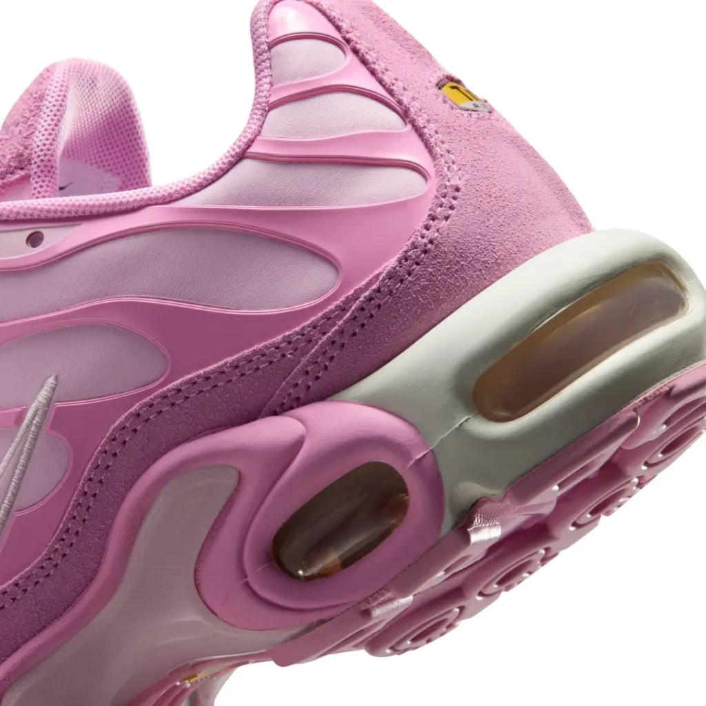 Close-up of the Air Max Plus heel highlighting the visible Air cushioning, suede mudguard, and layered pink midsole