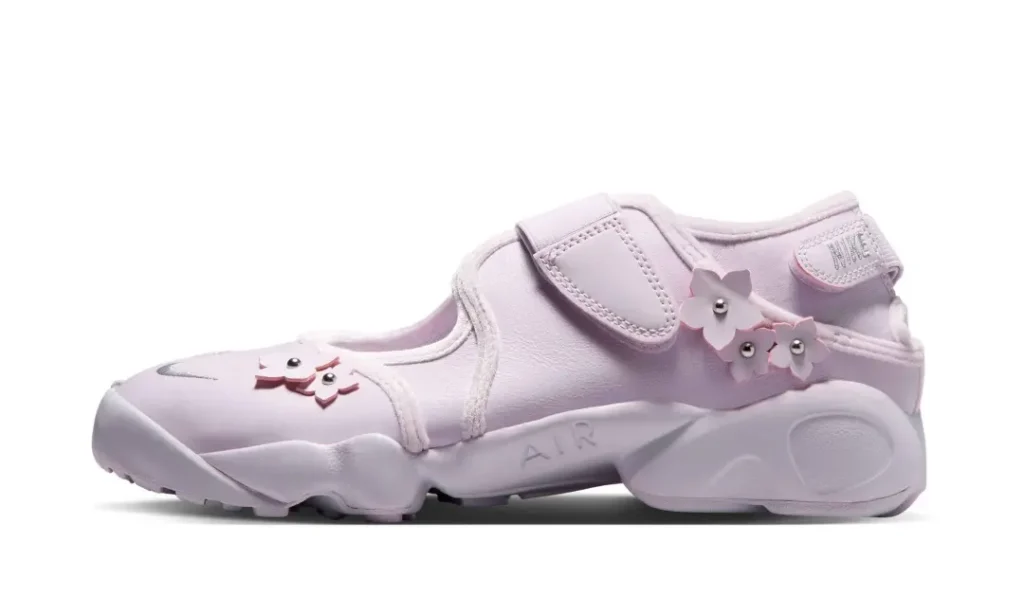 Medial profile of the pastel pink Nike Air Rift highlighting stitched paneling, adjustable strap system, and sculpted sole