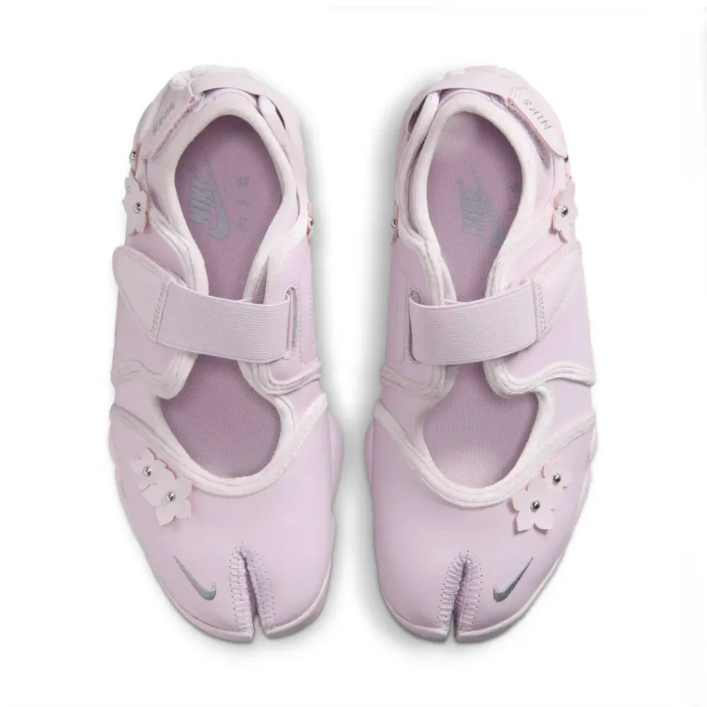 Overhead view of the Air Rift pair showcasing the split-toe construction, hook-and-loop straps, floral embellishments, and Nike Air-branded footbed