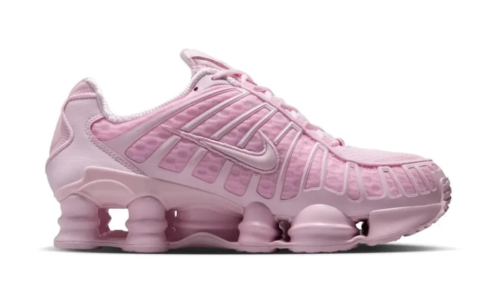 Medial profile of the pastel pink Nike Shox TL displaying the layered mesh upper, TPU support structure, and signature Shox cushion column