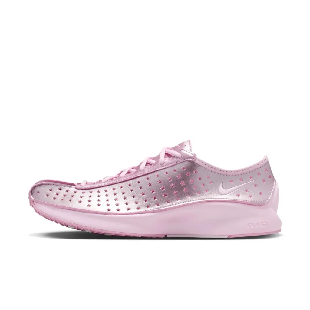 Side profile of a metallic pink Nike Air shoe with star-shaped perforations across the upper, tonal Swoosh, and a pink cushion midsole