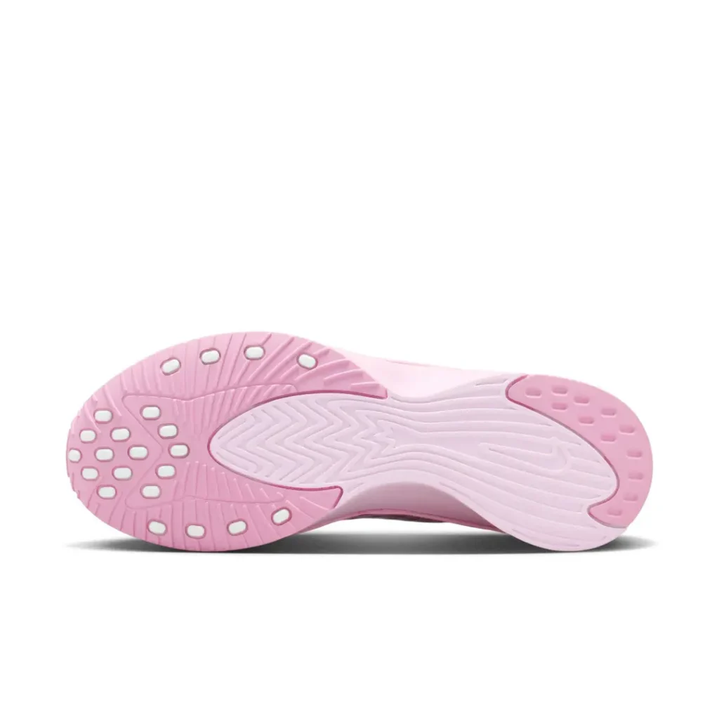 Bottom view of the pink Nike Air shoe showing a sculpted rubber outsole with segmented traction pods and a central Nike logo
