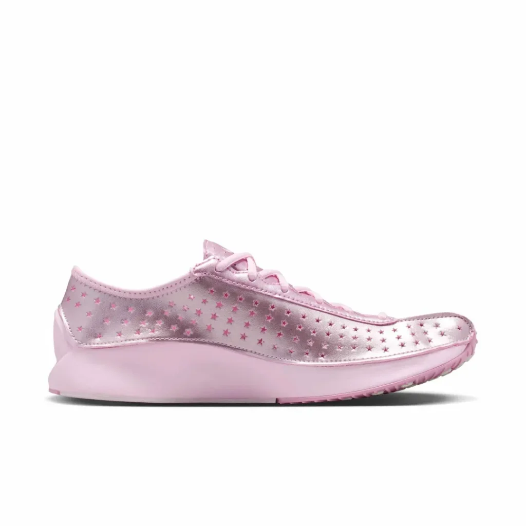 Medial side view of the metallic pink Nike Air sneaker with star perforations and a streamlined low-profile sil