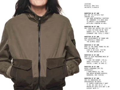 Breanna Stewart smiles while posing against a white studio backdrop wearing a two-tone Stone Island zip-front jacket with the brand's signature compass badge on the left sleeve, hands tucked into the front pockets. A column of printed interview questions and answers appears beside her, outlining her achievements, inspirations, personal philosophy, and details about the featured Organic Panama Cotton + Nylon garment as part of Stone Island's "A Research Project in 100 Questions" campaign