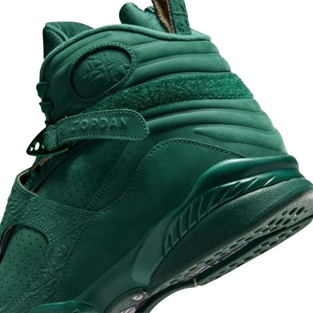Detailed rear-quarter close-up of the Air Jordan 8 x SoleFly sneaker highlighting the textured heel wrap, padded collar, embossed branding, and sculpted green mid