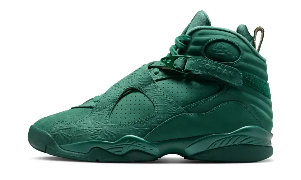 Lateral side profile of the Air Jordan 8 x SoleFly shoe showcasing monochromatic green leather, perforated side panels, embossed strap detailing, and sculpted heel cushion