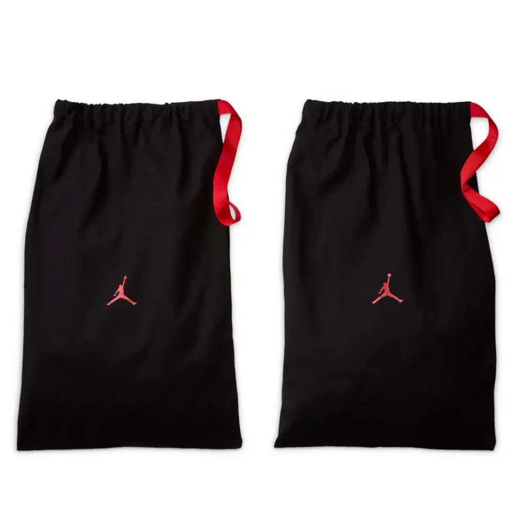 Black drawstring dust bags with embroidered red Jumpman logos and matching red pull cords included with the Air Jordan 8 x SoleFly release