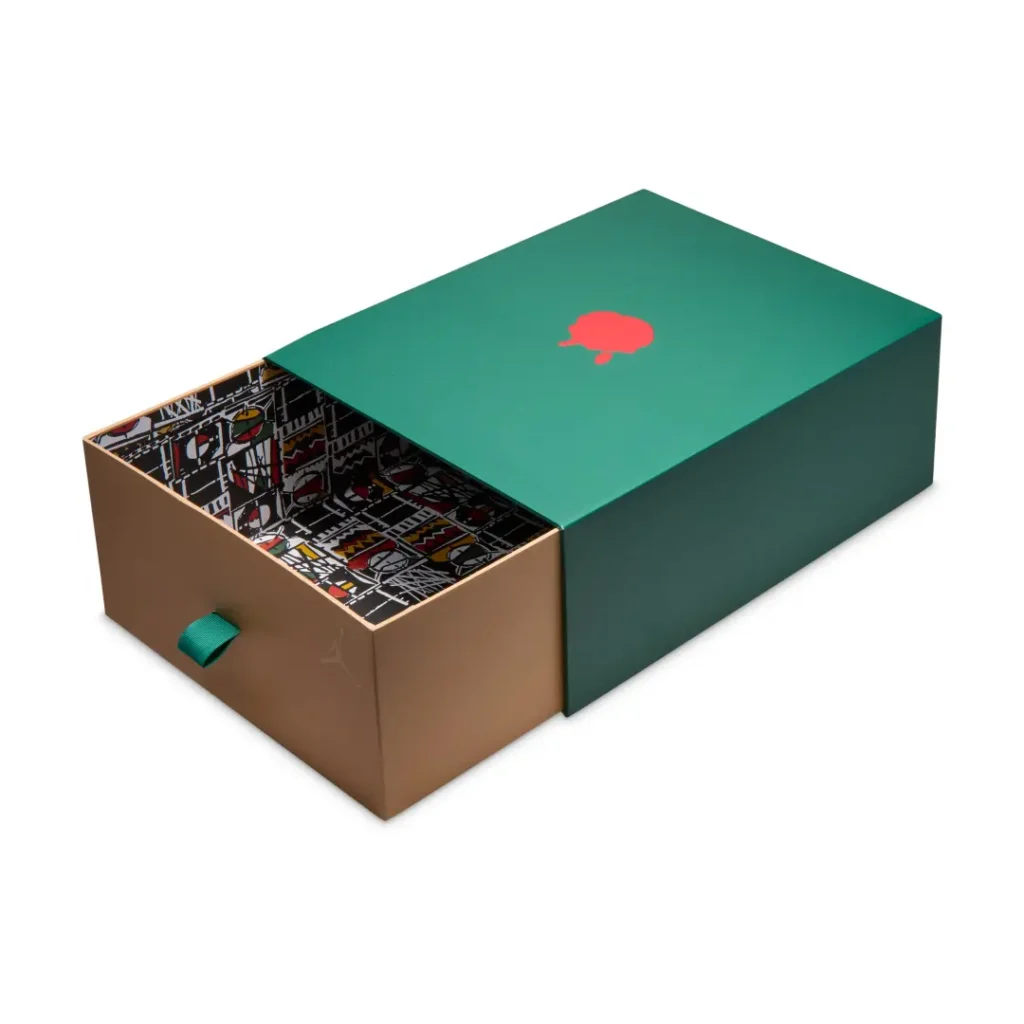 Premium slide-out Air Jordan x SoleFly shoebox featuring a dark green lid with a red wax seal graphic and a patterned interior drawer with green fabric pull tab