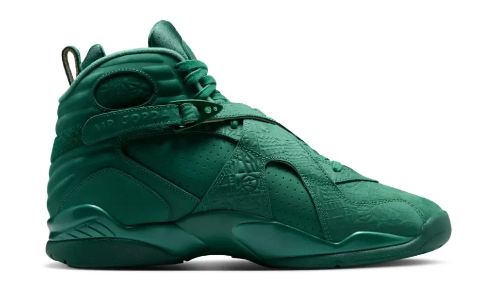 Medial side profile of the Air Jordan 8 x SoleFly shoe highlighting perforated leather panels, embossed crossover straps, tonal green construction, and padded ankle collar
