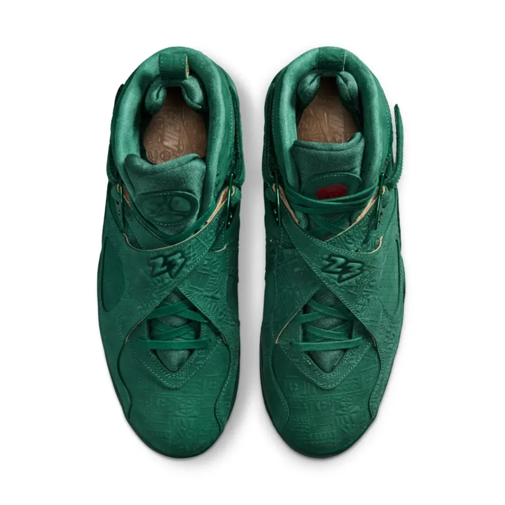 Top-down view of the Air Jordan 8 x SoleFly shoe showcasing crossover straps with raised "23" branding, green laces, padded collars, and patterned footbed