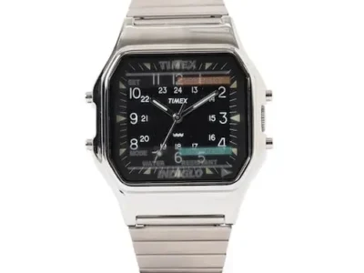 Front view of the Timex × BEAMS analog-digital wristwatch in polished stainless steel, featuring a black dial, white Arabic numerals, analog hands, digital display windows, and a silver expansion bracelet
