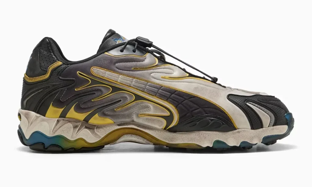 A medial side profile reveals the sneaker's layered construction, black and yellow flowing overlays, aged finish, sculpted sole unit, and translucent blue traction elements extending across the forefoot and heel